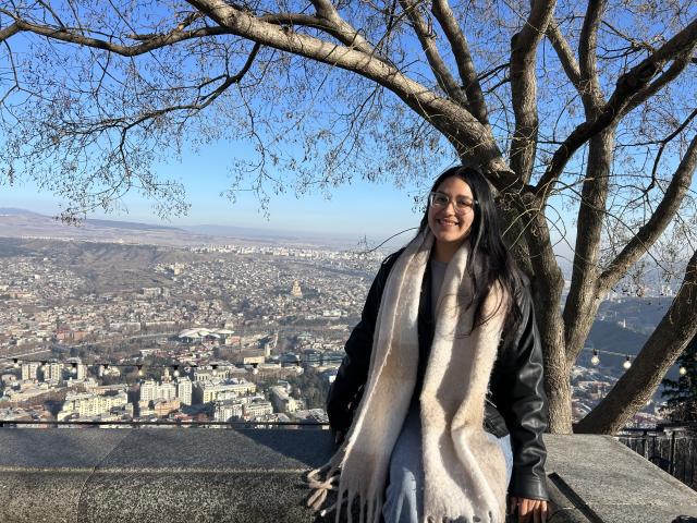 Lizbeth pictured with a view from the top of Tbilisi behind her. 